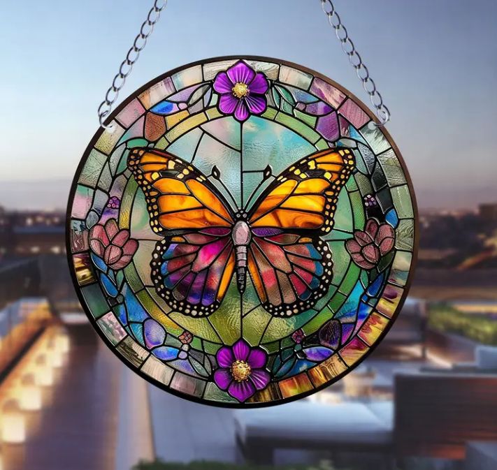 Stained glass acrylic butterfly suncatcher with purple flowers.