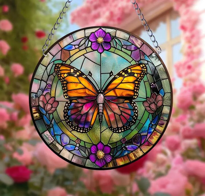 Stained glass acrylic butterfly suncatcher with purple flowers.