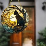 Black cat with moon and trees suncatcher, perfect for Halloween décor.